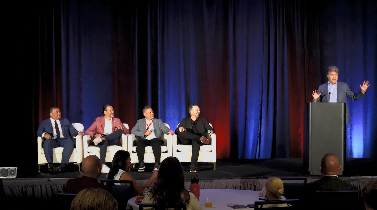 Speaker presenting to a conference audience.