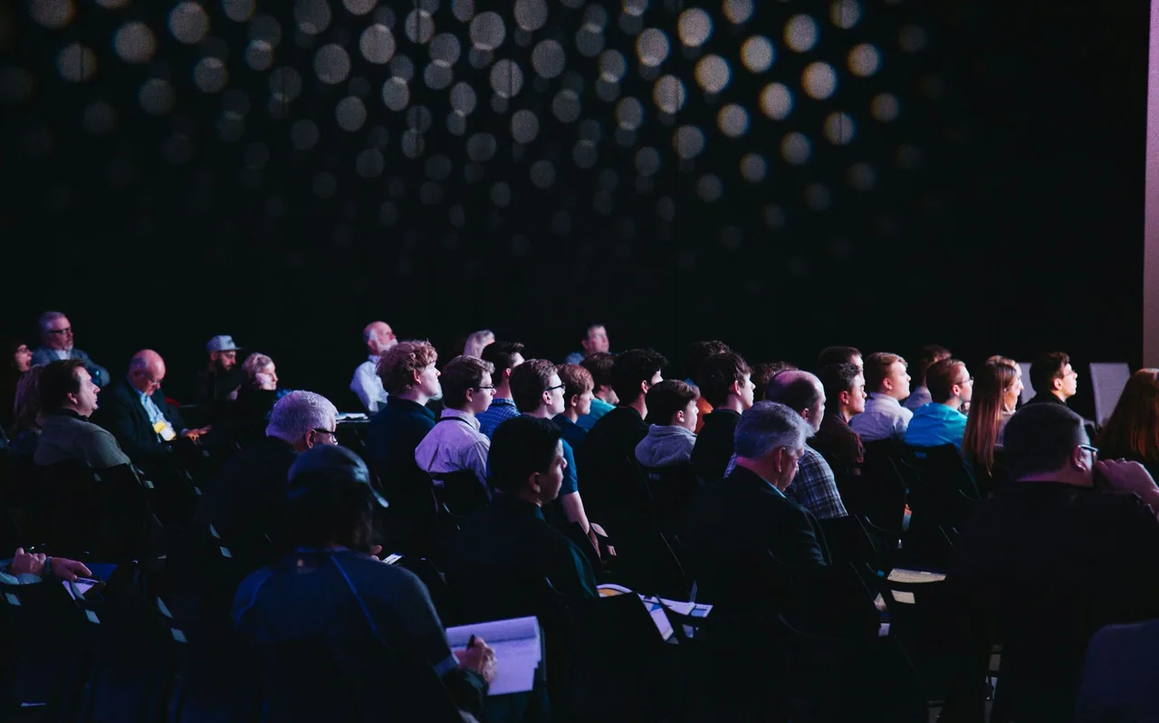 Audience seated for a conference keynote.